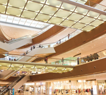 Bright multi-level shopping mall with escalators